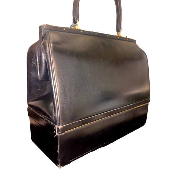 Hermès vintage Sac Mallette vanity trunk top handle bag, angled view of the black leather and structured lower compartment