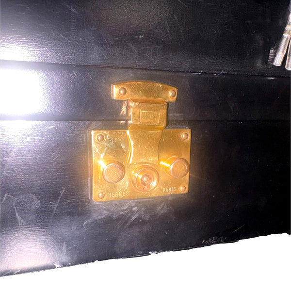 Hermès vintage Sac Mallette vanity trunk top handle bag, close-up of the gold-plated front lock and visible leather wear