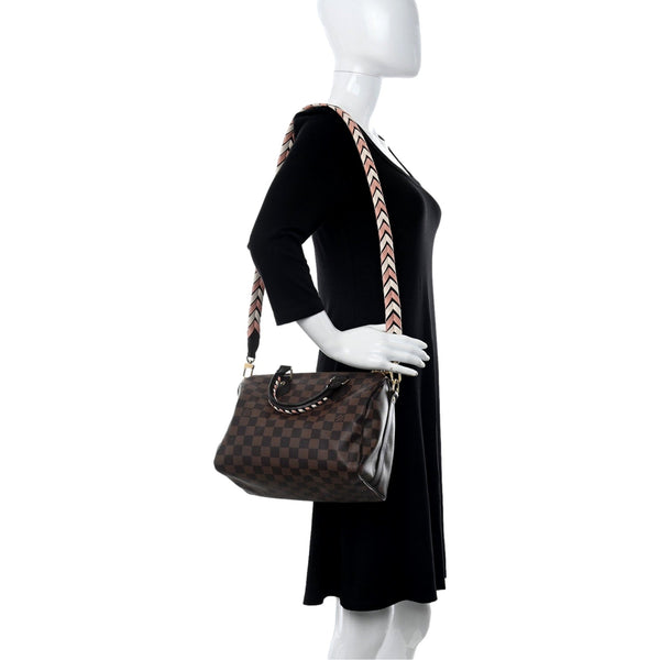 Louis Vuitton Damier Ebene Braided Speedy Bandouliere 25 Pink – carrying view