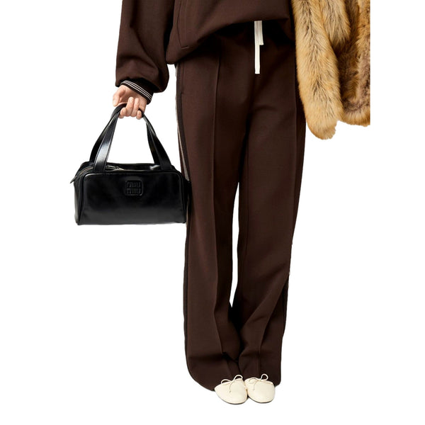 Supplier model carrying the Miu Miu black leather top handle bowler bag