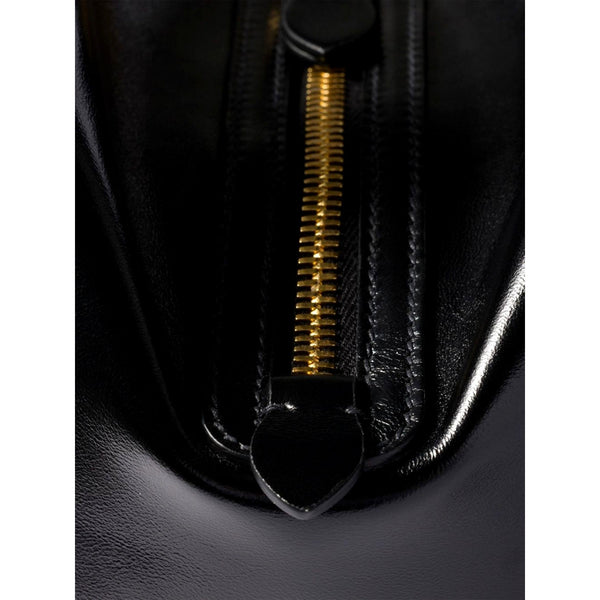 Close-up of the gold-tone zipper on the Miu Miu black leather bowler bag